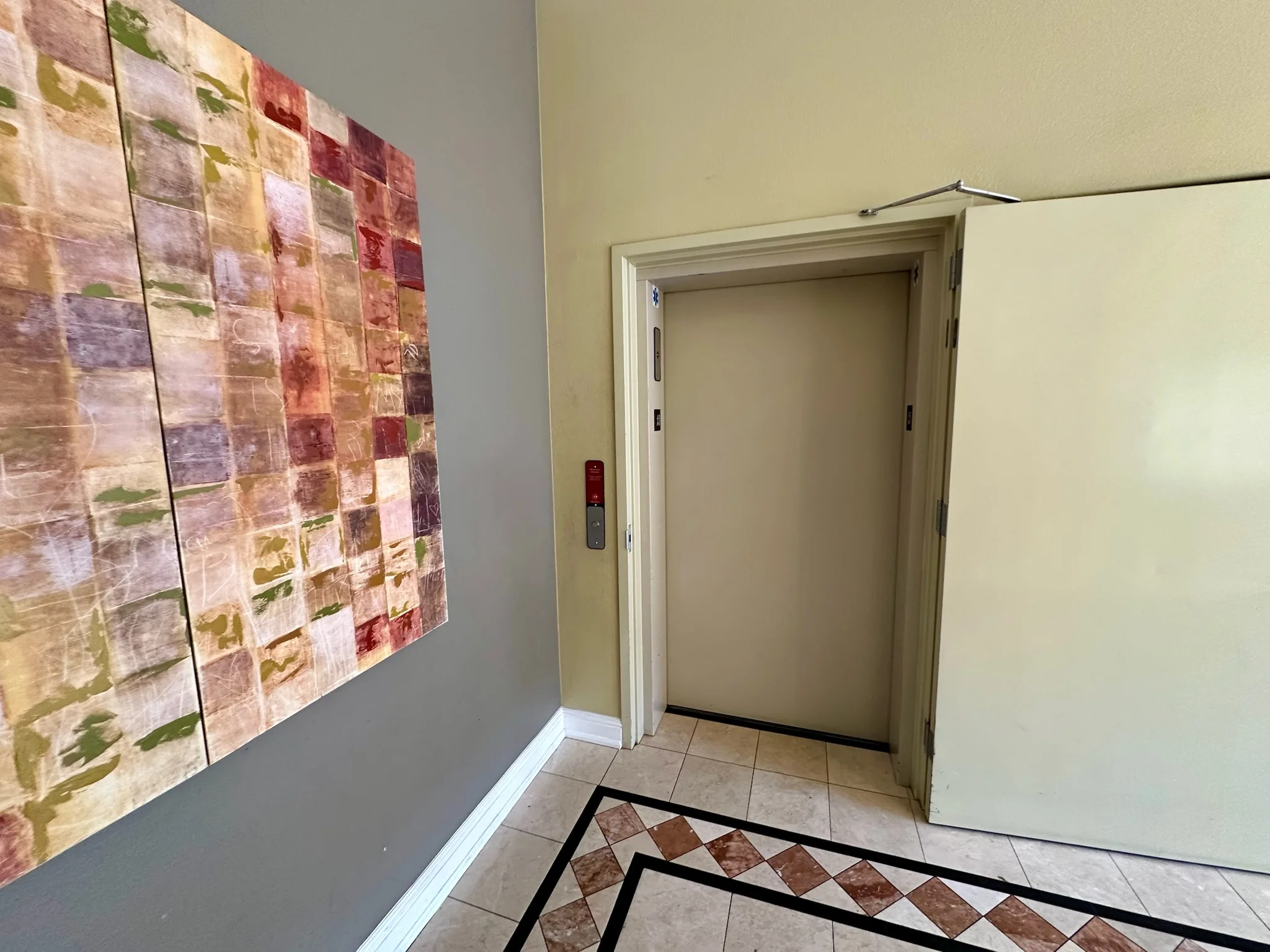 Elevator area with artwork in the lobby at Monterey Terrace Apartments Gilroy